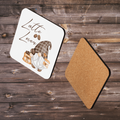 A Product image of 1 of 4 coasters with a watercolor gnome, illustrated with coffee a bag of coffee beans with the words Latte Lover