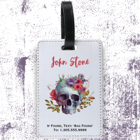 A product image of a luggage tag with the traveler's full name, if found text keyword and mobile phone number, printed with a skull surrounded by colorful flowers