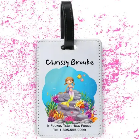 A product image of a luggage tag with the traveler's full name, if found text keyword and mobile phone number, printed with an underwater scene of a rocks, a cute mermaid, bold color corals, fish, starfish, and a seahorse