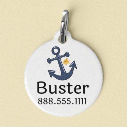 A product image of a personalized pet ID tag with a blue anchor and a cute yellow fish for the marine fan, with your pet's name and a phone number