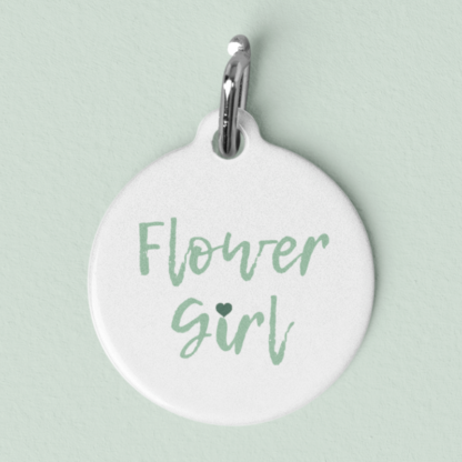 A product image of a pet id tag with words Flower Girl printed on it with a heart as the I in girl