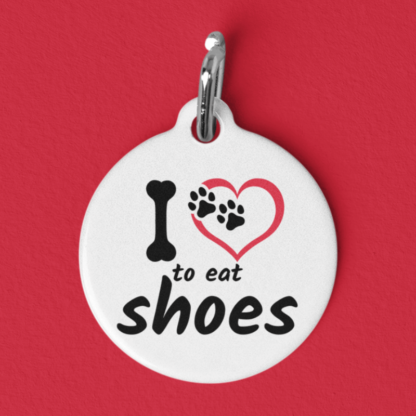 Product image of a pet id tag that says I love to eat shoes with a heart, in place of love, with paw prints