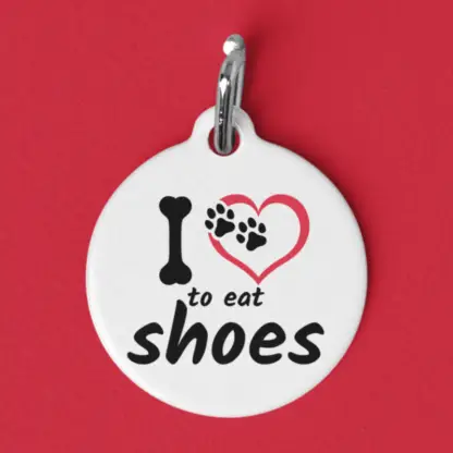 Product image of a pet id tag that says I love to eat shoes with a heart, in place of love, with paw prints