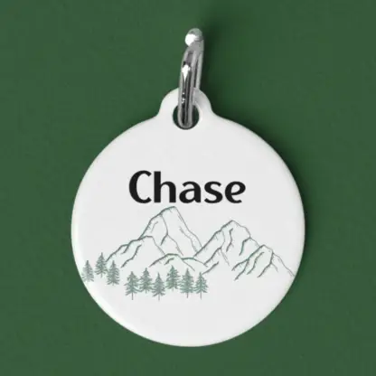 A product image of a customized aluminum pet id tag with a mountain range and trees with your pet's name