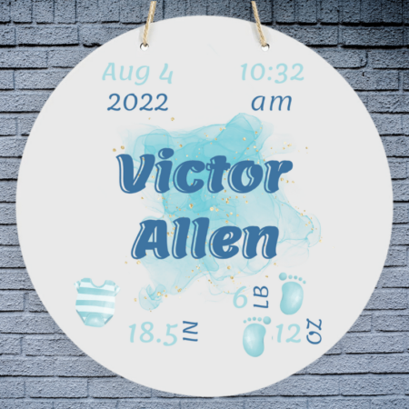 A product image of a personalized baby boy photo prop announcement with the baby's first name, baby's middle name, baby's length in inches, baby's weight in pounds and ounce, baby's date of birth, and the baby's time of birth, printed with an alcohol ink background, illustrated watercolor baby footprints, and a baby's striped blue outfit