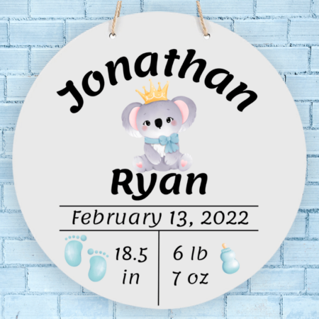 A product image of a personalized baby boy photo prop announcement with the baby's first name, baby's middle name, baby's length in inches, baby's weight in pounds and ounce, baby's date of birth, printed with an alcohol ink background, illustrated watercolor baby footprints, and a baby's bottle with a watercolor koala baby