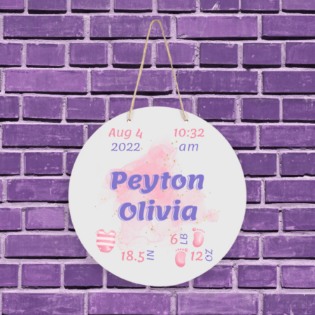 A product image of a personalized baby girl photo prop announcement with the baby's first name, baby's middle name, baby's length in inches, baby's weight in pounds and ounce, baby's date of birth, time of birth, printed with an alcohol ink background, illustrated watercolor baby footprints, and a a pink striped outfit