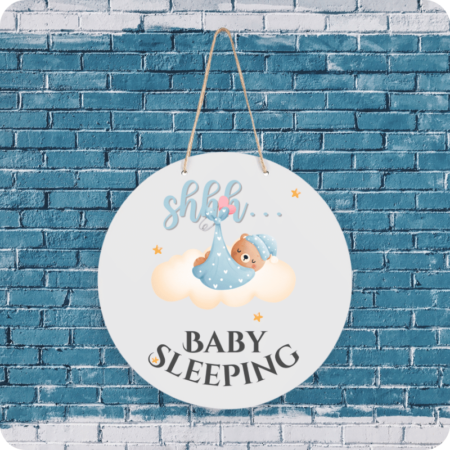 A product image of a baby sign with illustrated watercolor bear wrapped in a blanket, sleeping on a cloud and printed with the words Shhh... Baby Sleeping