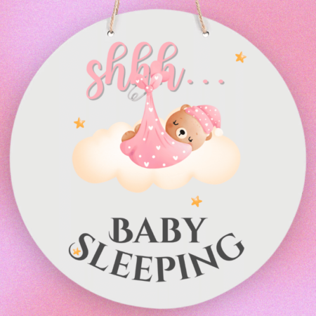 A product image of a baby sign with illustrated watercolor bear wrapped in a blanket, sleeping on a cloud and printed with the words Shhh... Baby Sleeping