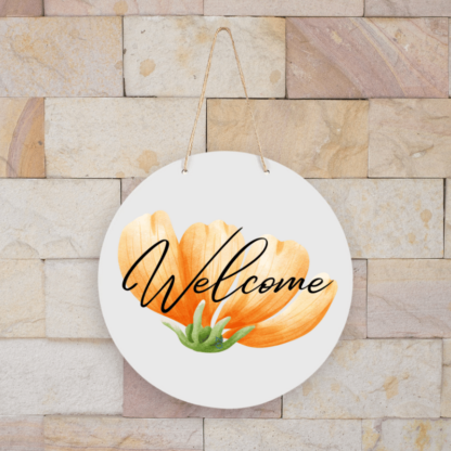 A product image of a hanging sign with a beautiful spring flower background, rendered in watercolor orange and green and printed with the world Welcome