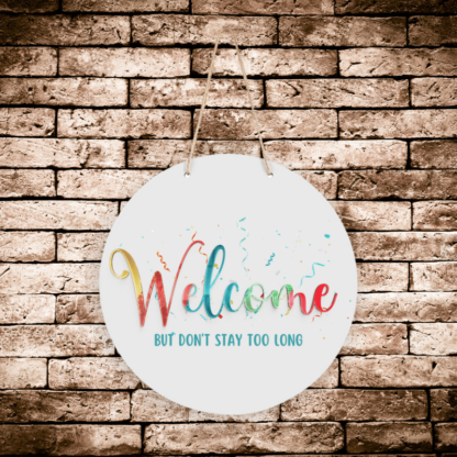 A product image of a hanging welcome sign with a party theme, printed with the words Welcome but don't stay too long