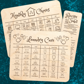 A product image of laser cut wood card set that has been engraved with a monthly schedule of chores, recipe substitutes, and a chart on laundry care icons. Durable and ready to use