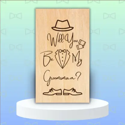 A product image of an engraved wedding party proposal card with a boy's Fedora, cufflinks, bow tie, button down, and lapels of a tuxedo, and dress shoes. The words Will You Be My Groomsman?