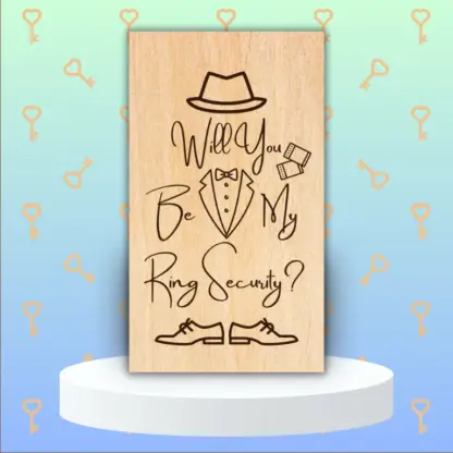 A product image of an engraved wedding party proposal card with a boy's Fedora, cufflinks, bow tie, button down, and lapels of a tuxedo, and dress shoes. The words Will You Be My Ring Security?