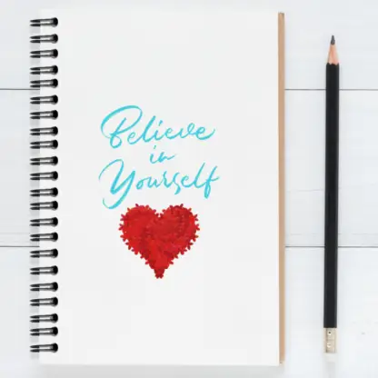 Product image of an motivational journal notebook, along side a pencil