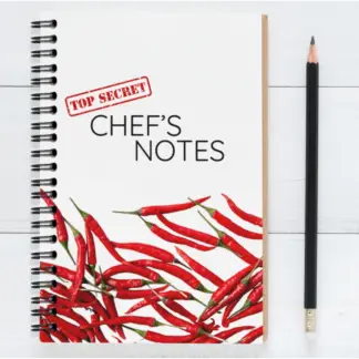 Product image of a cooking journal notebook, along side a pencil