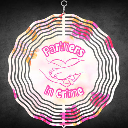 A product image of a 3D wind spinner with flower background. One side has a person's hand and a dog's paw with the words Partners in Crime. The second side has 2 hearts