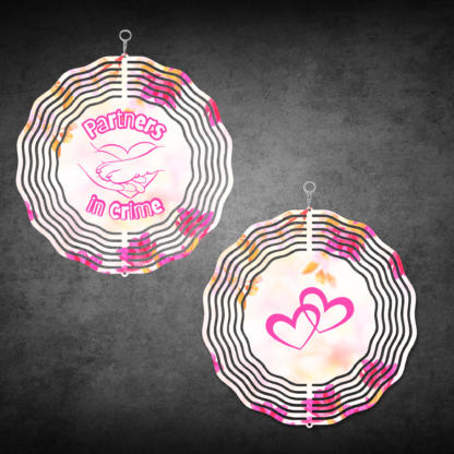 A product image of a 3D wind spinner with flower background. One side has a person's hand and a dog's paw with the words Partners in Crime. The second side has 2 hearts